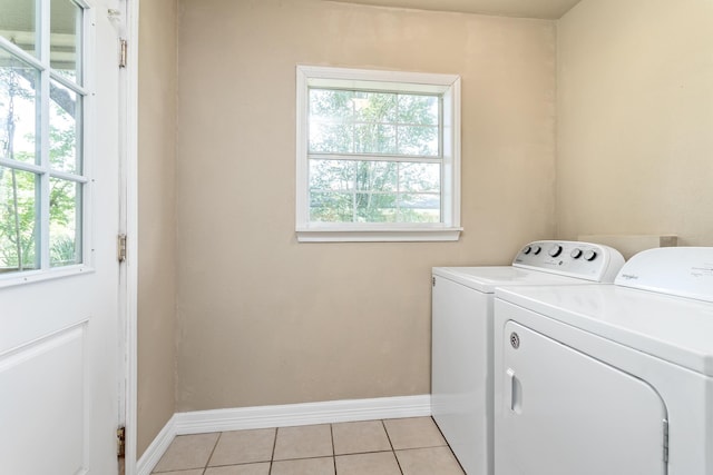 10775 Old Voth Rd, Beaumont, TX 77713 - laundry room with washing machine and dryer, light tile patterned floors, and baseboards