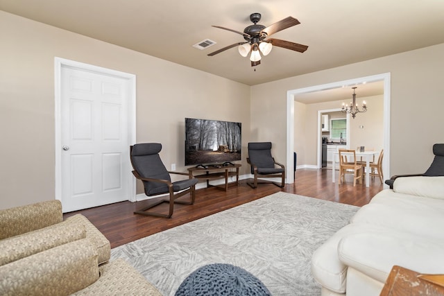 10775 Old Voth Rd, Beaumont, TX 77713 - living room with wood finished floors, ceiling fan, a chandelier, and baseboards