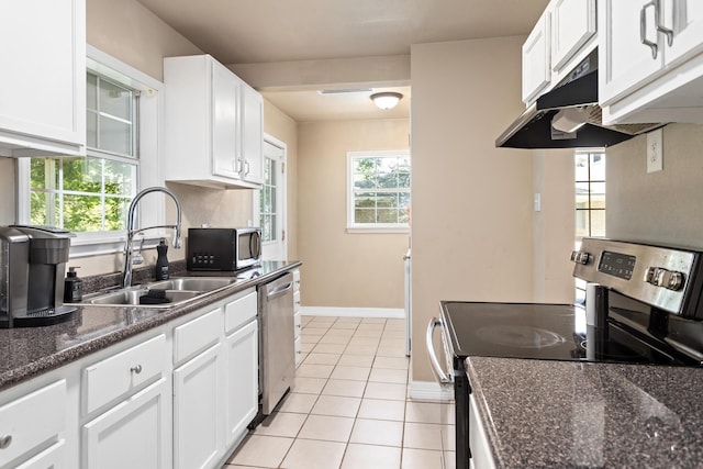 10775 Old Voth Rd, Beaumont, TX 77713 - kitchen with appliances with stainless steel finishes, a sink, baseboards, and white cabinets