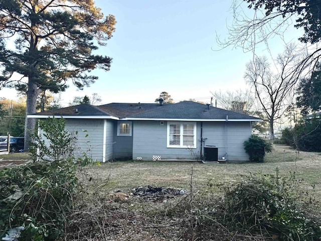 rear view of property with central AC