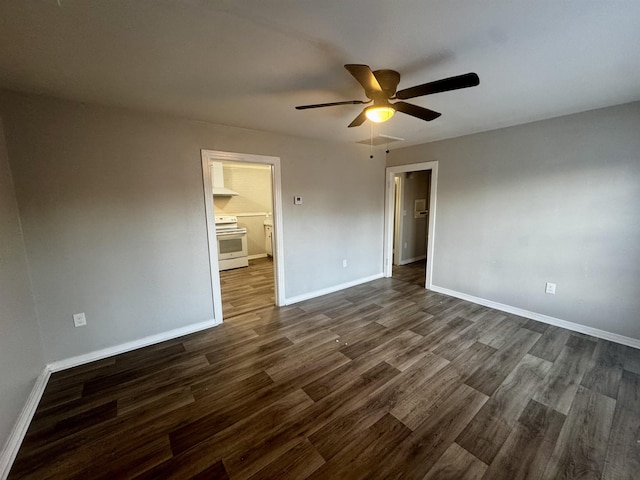 spare room with ceiling fan and dark hardwood / wood-style flooring