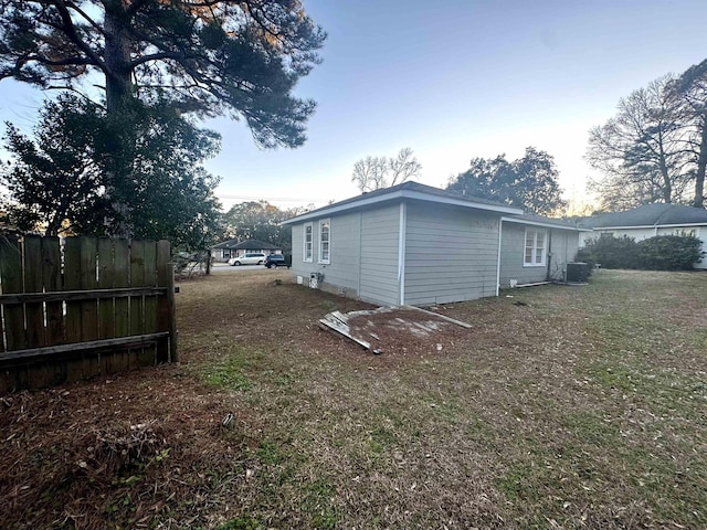 view of home's exterior featuring cooling unit and a lawn