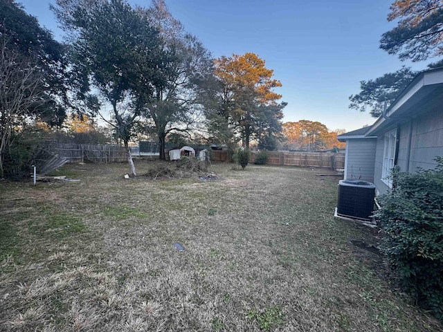 view of yard with a storage shed and central AC unit