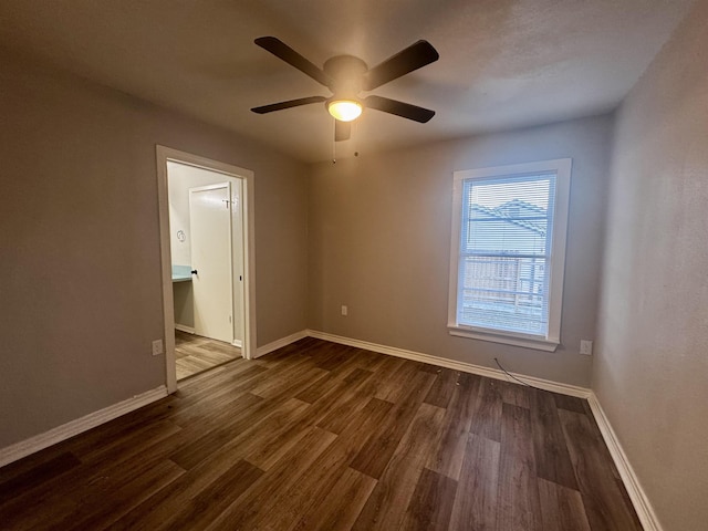 unfurnished room featuring dark wood-type flooring and ceiling fan