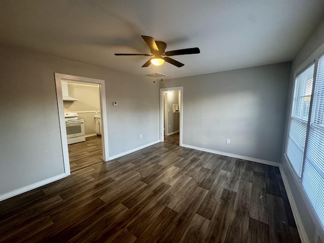 unfurnished bedroom with dark hardwood / wood-style floors, ceiling fan, and ensuite bath