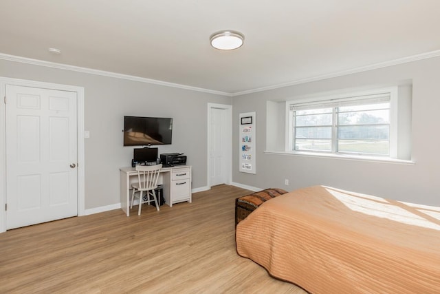 bedroom with light wood-type flooring and crown molding