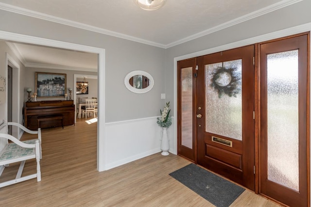 entrance foyer featuring crown molding and light wood-type flooring