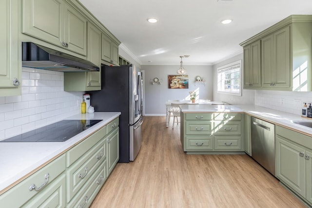 kitchen with backsplash, green cabinetry, decorative light fixtures, light hardwood / wood-style floors, and stainless steel appliances