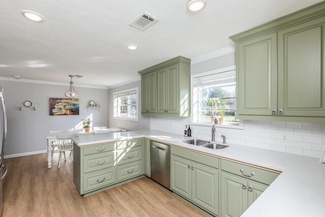 kitchen featuring kitchen peninsula, dishwasher, green cabinets, and decorative light fixtures