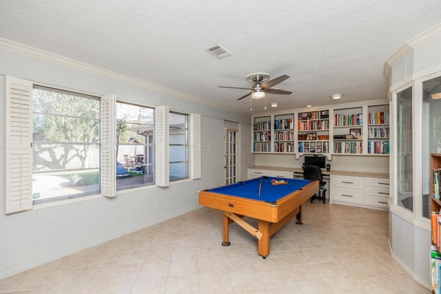 rec room featuring ornamental molding, brick wall, a textured ceiling, ceiling fan, and pool table