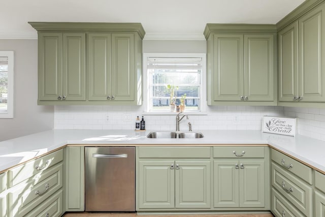 kitchen with crown molding, sink, stainless steel dishwasher, and green cabinetry