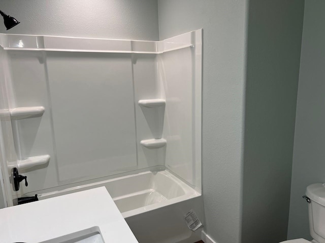 full bathroom featuring a textured wall, shower / washtub combination, and toilet