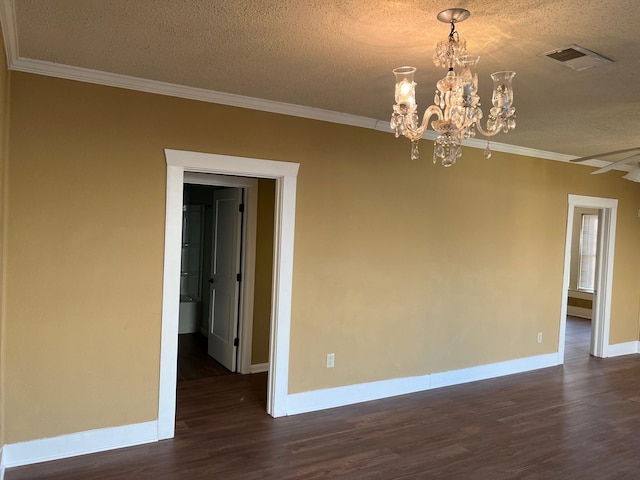 unfurnished room featuring ornamental molding, dark wood-style flooring, and visible vents