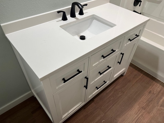 bathroom with vanity and wood finished floors