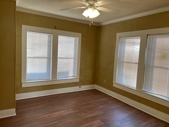 spare room with ornamental molding, dark wood-style flooring, ceiling fan, and a textured ceiling