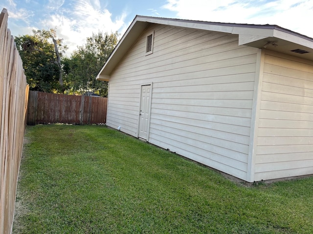 view of side of property with a fenced backyard and a lawn