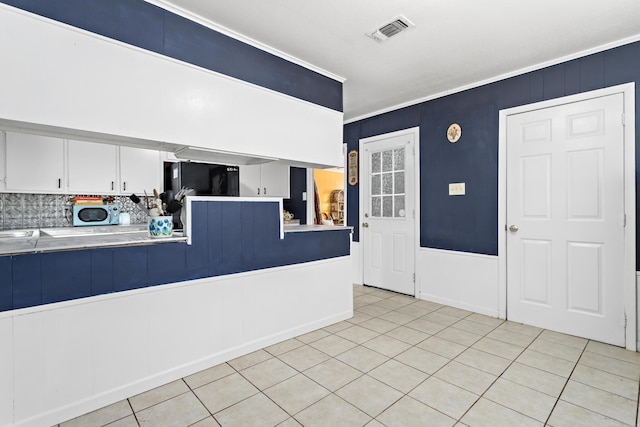 tiled entrance foyer with ornamental molding