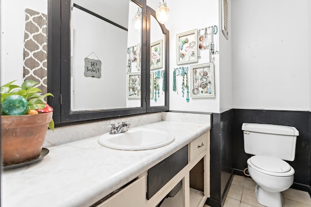 bathroom featuring tile patterned floors, vanity, and toilet