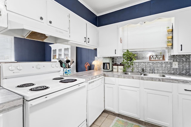 kitchen featuring tasteful backsplash, white appliances, sink, white cabinets, and light tile patterned flooring