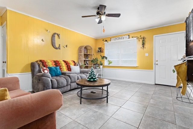 living room with ceiling fan, light tile patterned floors, and ornamental molding