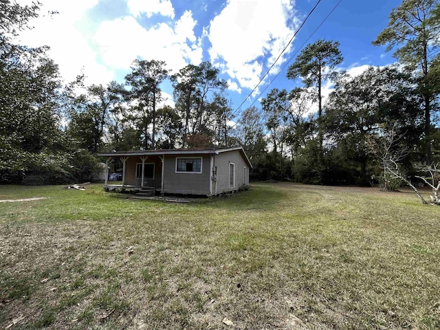 138 Ned Rd, Lumberton, TX 77657 - view of grassy yard with covered porch and view of scattered trees