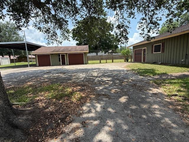 176 Ridgewood St, Bridge City, TX 77611 - garage featuring dirt driveway and a detached garage