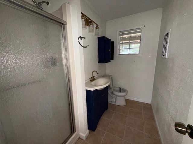 176 Ridgewood St, Bridge City, TX 77611 - full bath with a shower stall, vanity, and tile patterned floors
