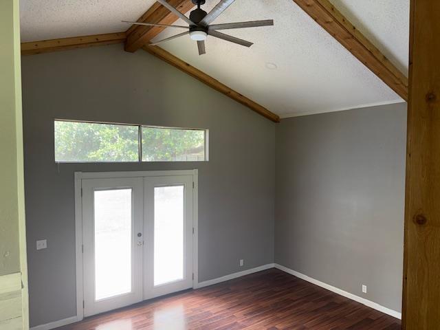176 Ridgewood St, Bridge City, TX 77611 - empty room featuring a ceiling fan, dark wood-style floors, healthy amount of natural light, french doors, and a textured ceiling