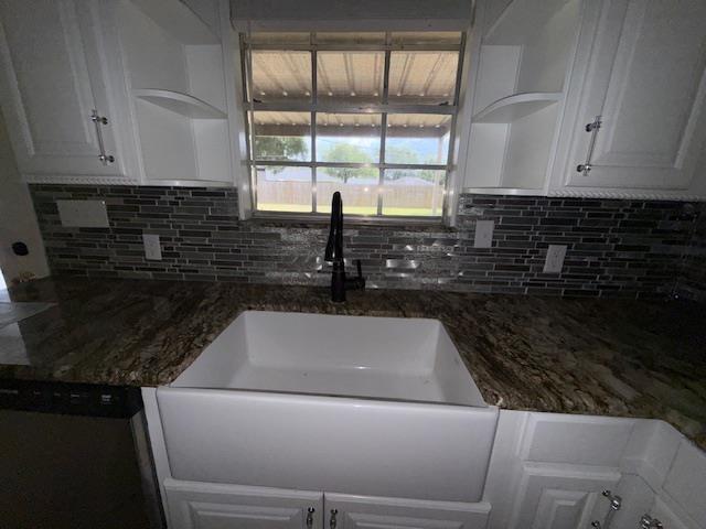 176 Ridgewood St, Bridge City, TX 77611 - kitchen featuring white cabinets, decorative backsplash, and dishwasher