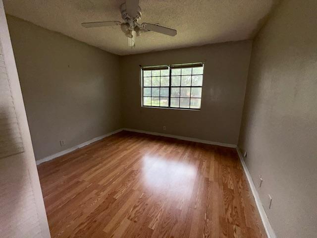 176 Ridgewood St, Bridge City, TX 77611 - unfurnished room with wood finished floors, ceiling fan, and a textured ceiling