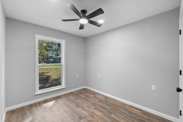 unfurnished room with dark hardwood / wood-style flooring and ceiling fan