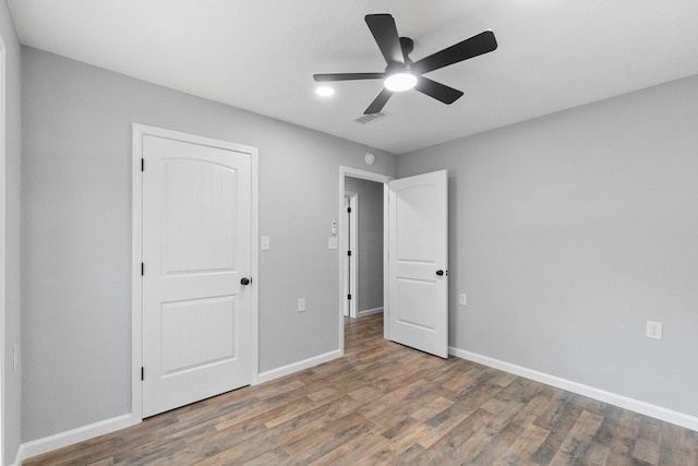 unfurnished bedroom featuring ceiling fan and wood-type flooring