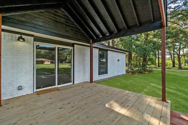 wooden terrace featuring a lawn