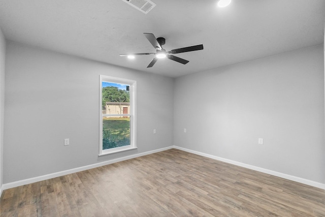 empty room with hardwood / wood-style floors and ceiling fan