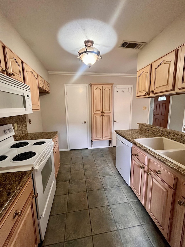 kitchen featuring white appliances, dark countertops, a sink, light brown cabinets, and ornamental molding