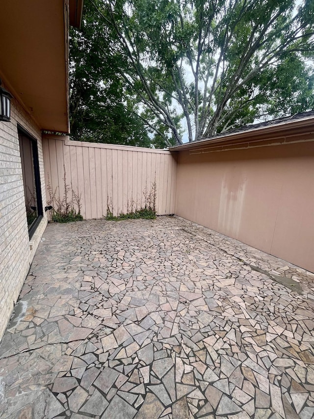 view of patio featuring fence