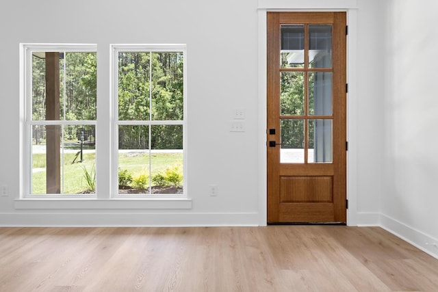 doorway to outside with light wood-type flooring