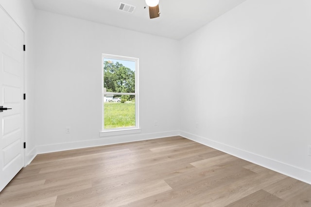 empty room with ceiling fan and light hardwood / wood-style floors