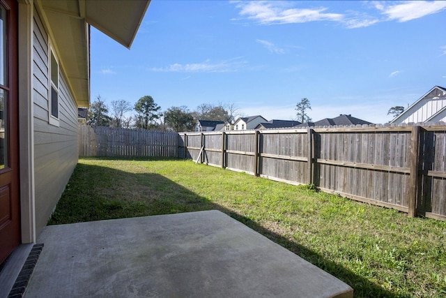 view of yard with a patio area and a fenced backyard