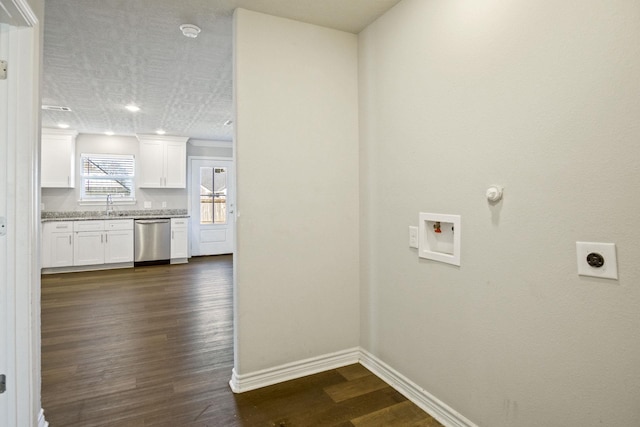 clothes washing area featuring baseboards, laundry area, dark wood-style floors, hookup for an electric dryer, and a sink