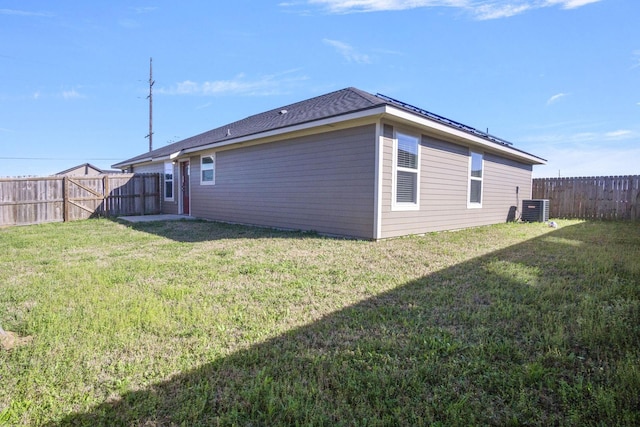 view of home's exterior featuring a fenced backyard, central air condition unit, and a yard