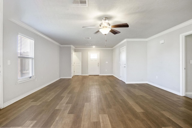 unfurnished living room with visible vents, baseboards, dark wood-style floors, and crown molding