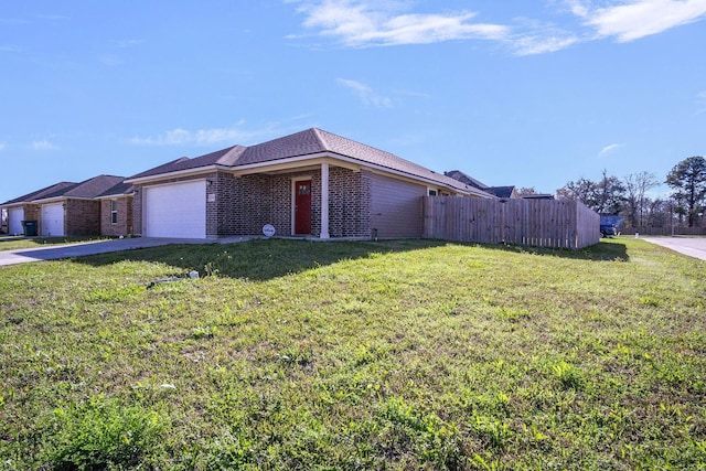 view of front of house with brick siding, fence, a front yard, driveway, and an attached garage