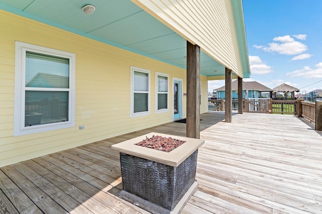 wooden terrace with a fire pit