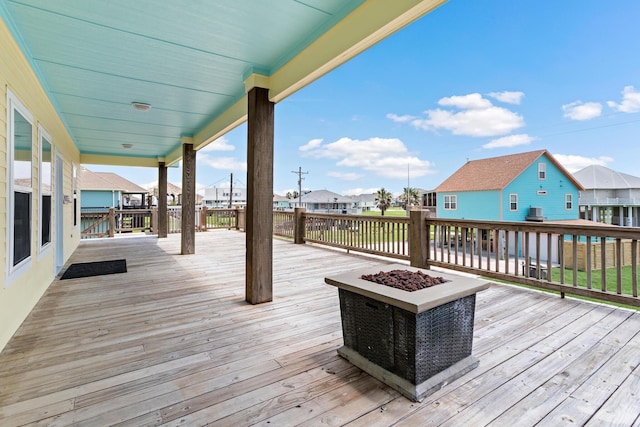 wooden terrace featuring a fire pit