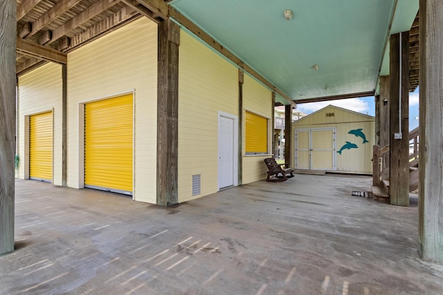 exterior space featuring a storage unit and a patio