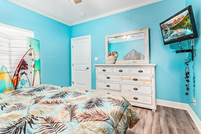 bedroom featuring light hardwood / wood-style flooring and crown molding