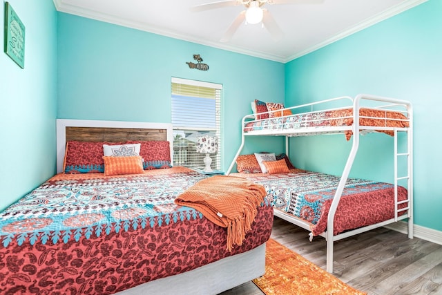 bedroom featuring wood-type flooring, ceiling fan, and crown molding