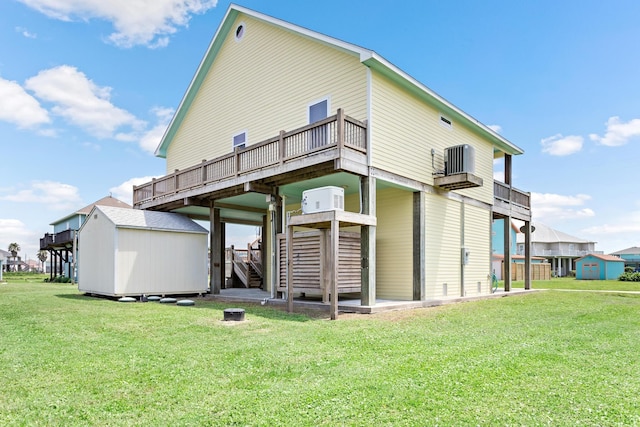 back of property with a deck, a yard, central AC unit, and a storage unit