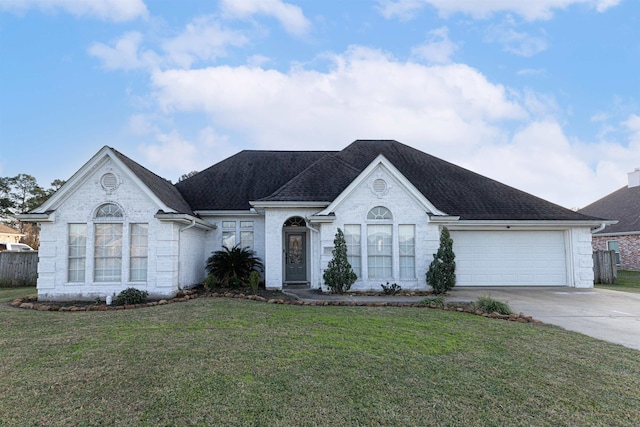 735 Jacob Cir, Orange, TX 77630 - view of front of house featuring concrete driveway, a garage, a front lawn, brick siding, and a shingled roof